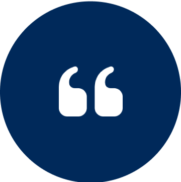 Here's an alt tag for the image: `White quotation marks on dark blue circle`